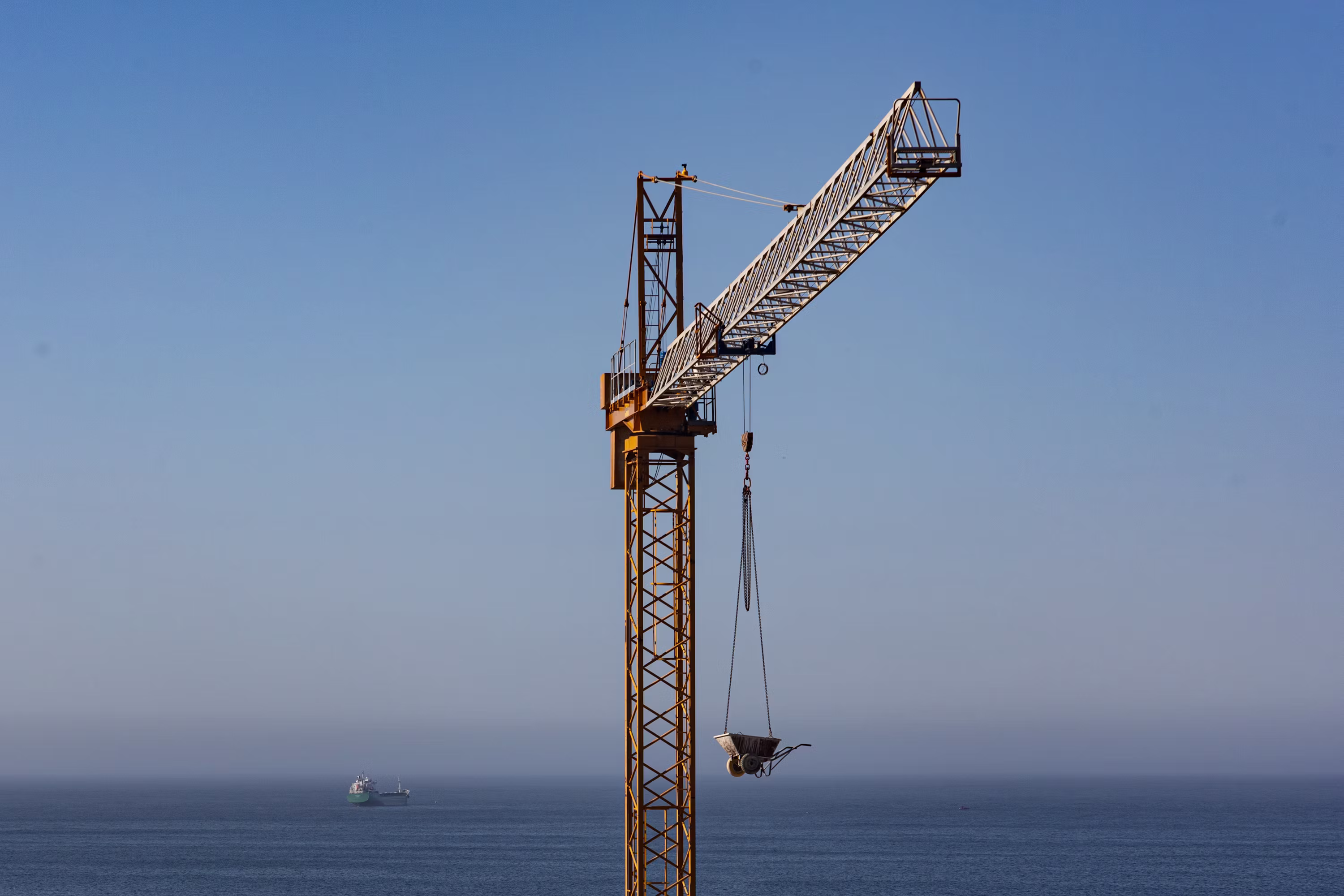 Tower crane over a construction site at dusk
