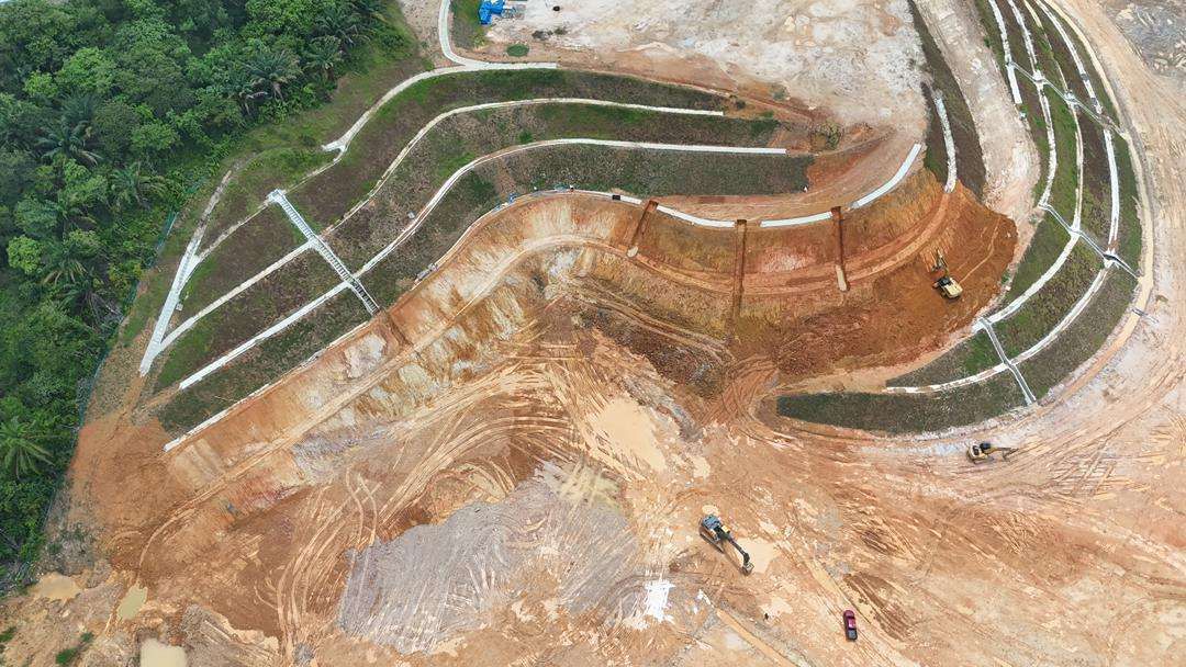 Aerial view of terraced earthworks and slope cut