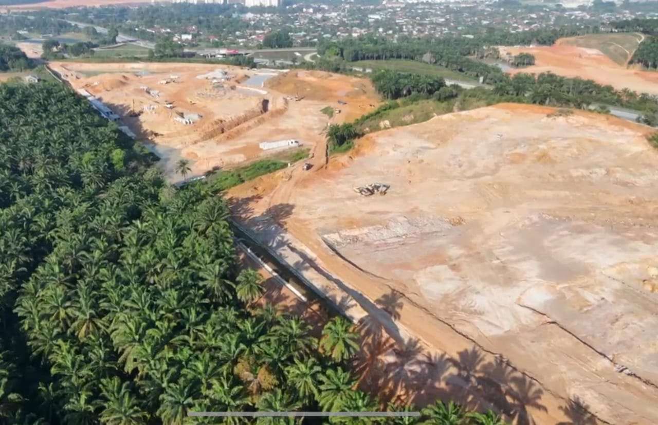 Aerial view of drainage and earthworks beside palm estate at Lagong Mas