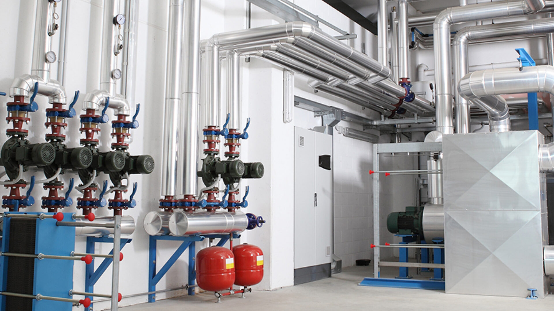 Mechanical and electrical plant room with insulated pipework, pumps and valves